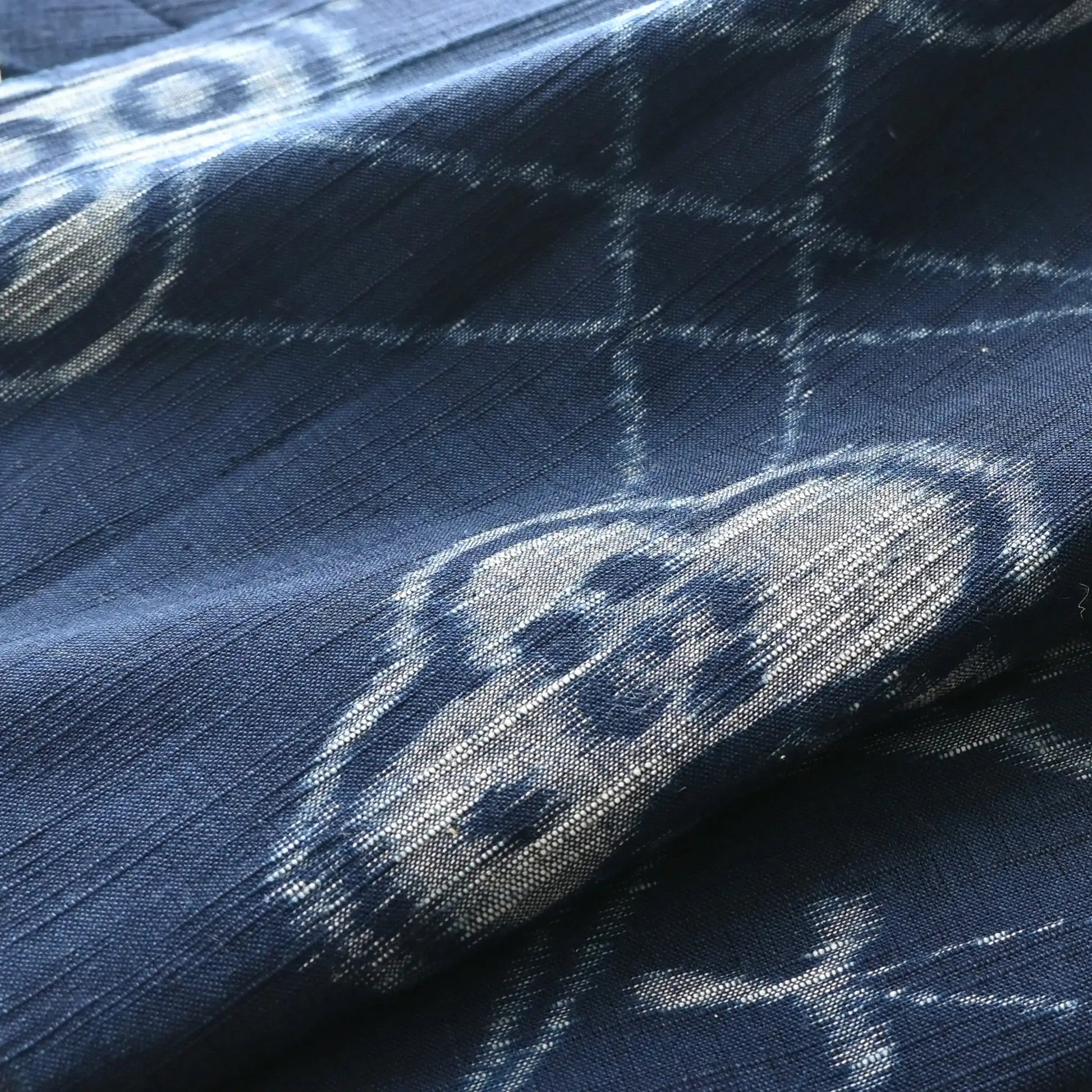 Detailed view of vintage Japanese indigo egasuri cotton, pine tree motif with a beautiful texture.