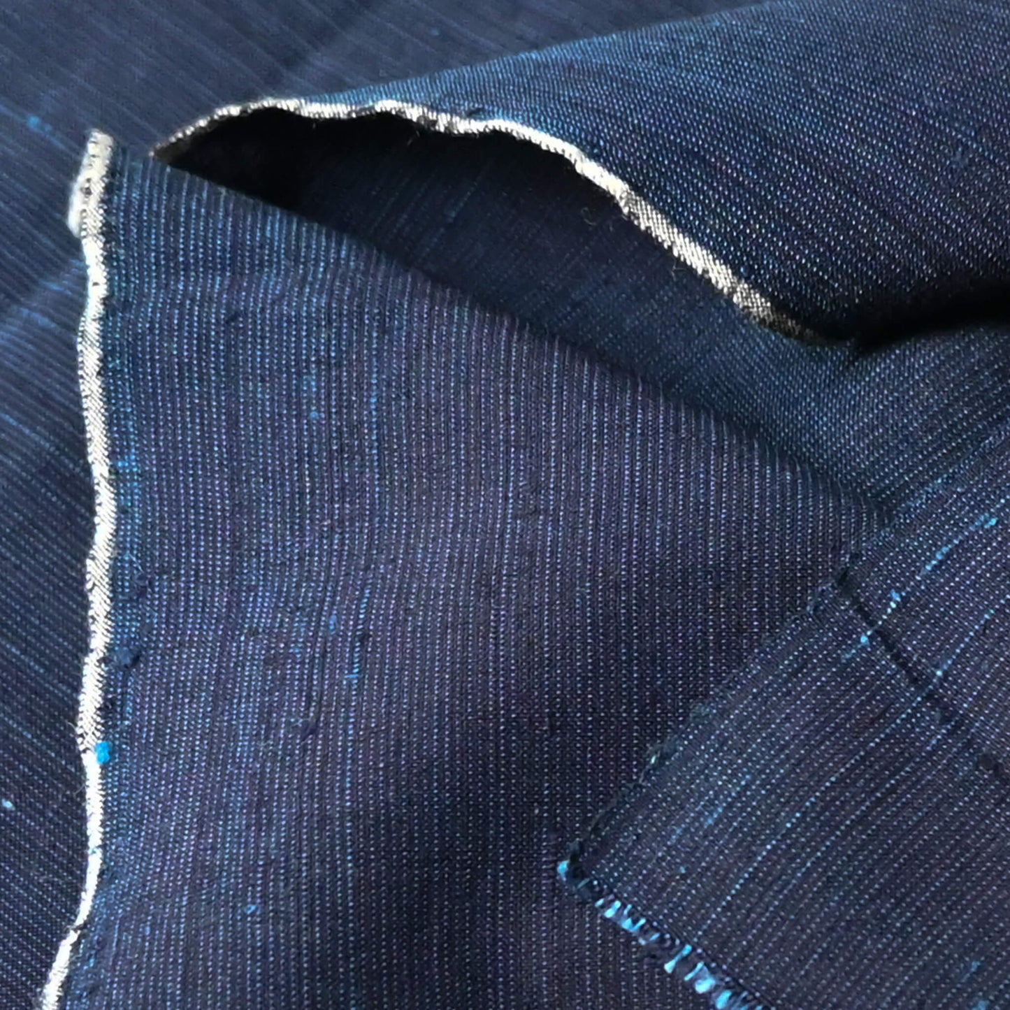 Close-up view of vintage fine stripe indigo cotton piece from undone kimono.