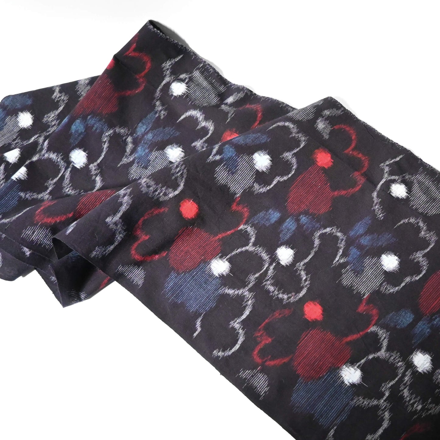 Full view of vintage indigo kasuri cotton kimono fabric with bold floral pattern in red and blue.