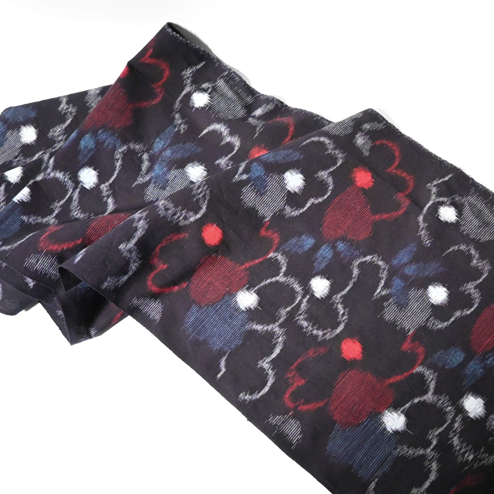 Full view of vintage indigo kasuri cotton kimono fabric with bold floral pattern in red and blue.