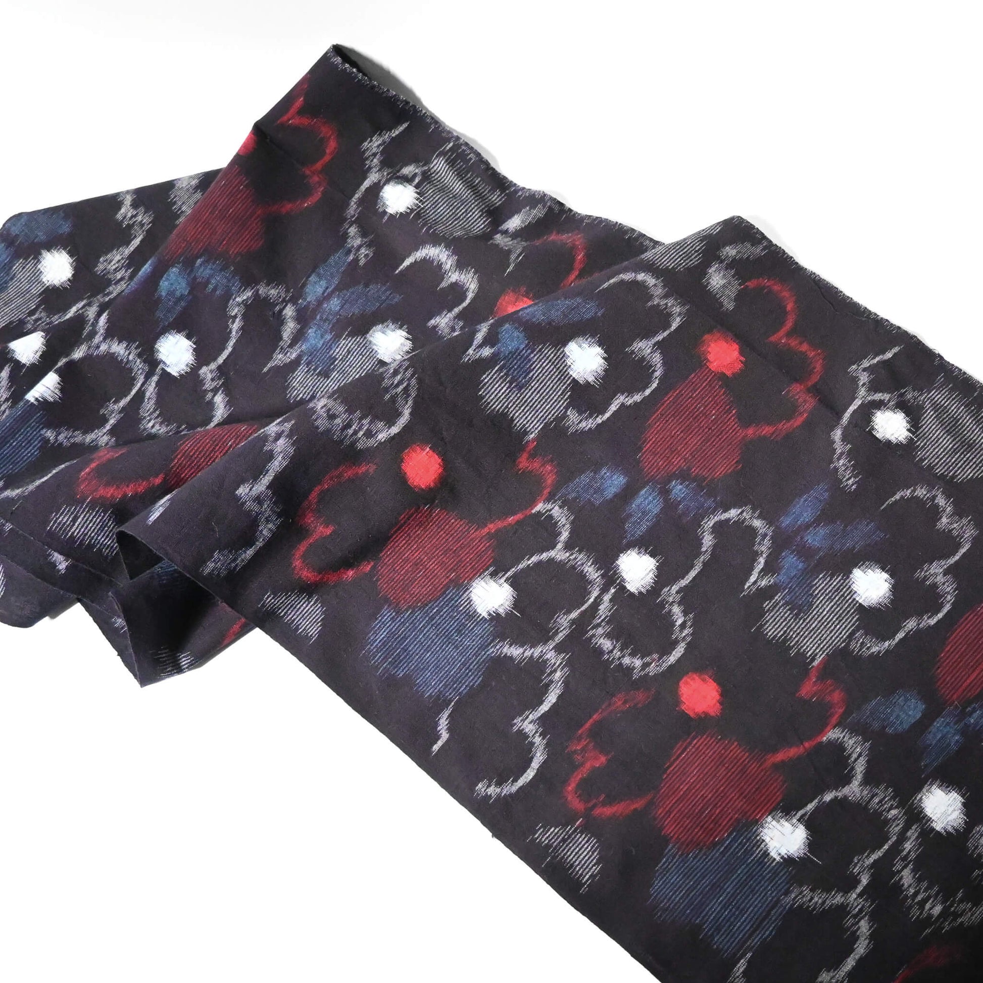 Full view of vintage indigo kasuri cotton kimono fabric with bold floral pattern in red and blue.