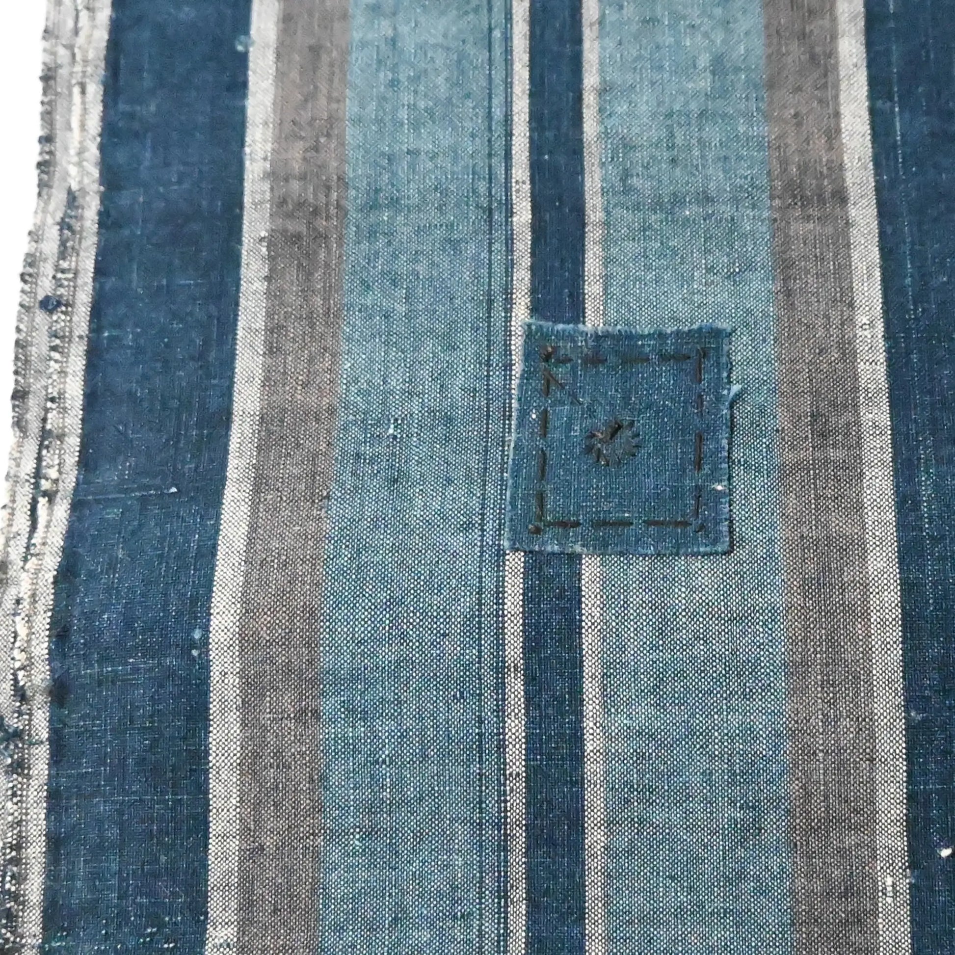 A mended patch of vintage Japanese indigo stripe cotton futon cover panel.