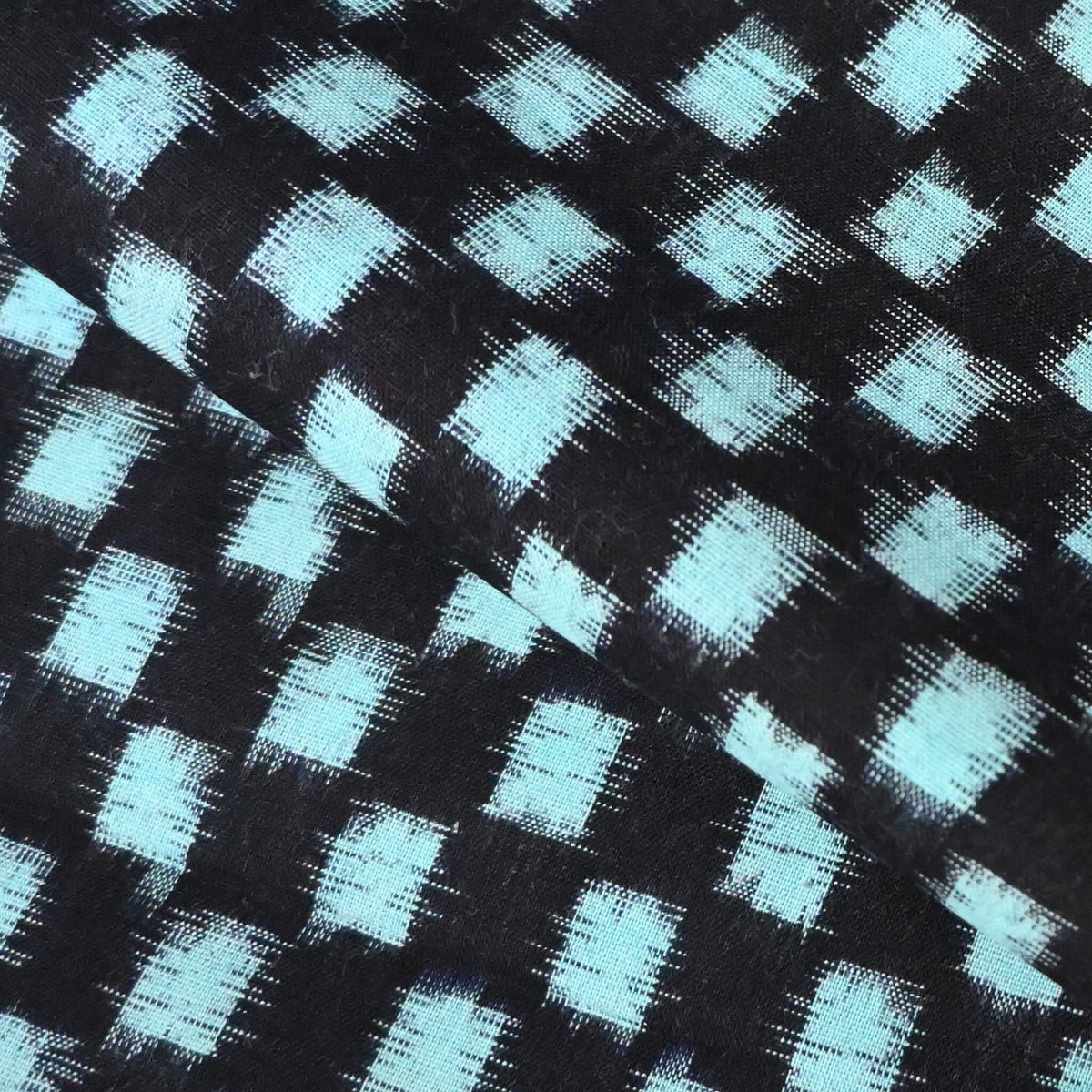 Close-up view of vintage Japanese indigo classic kasuri check cotton sold by the metre.