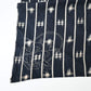 Detailed view of vintage three-panel indigo kasuri cotton furoshiki with hand stitched botanical motifs on the corner.