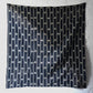 Full view of vintage three-panel indigo kasuri cotton furoshiki with hand stitched botanical motifs on the corner.
