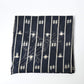 Vintage three-panel indigo kasuri cotton furoshiki with hand stitched botanical motifs on the corner.