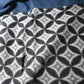 Detailed view of vintage Japanese indigo cotton Koshimaki, a traditional waist wrap, with Kasuri Shippō-tsunagi motif.