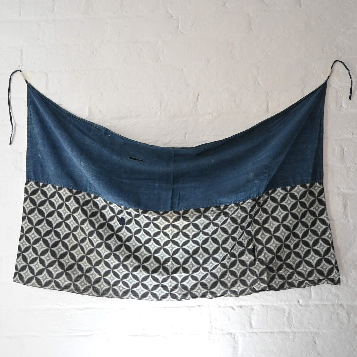 Full view of vintage Japanese indigo cotton Koshimaki, a traditional waist wrap, with Kasuri Shippō-tsunagi motif.