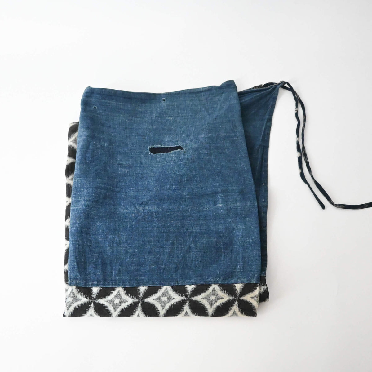 Vintage Japanese indigo cotton Koshimaki, a traditional waist wrap, with Kasuri Shippō-tsunagi motif.