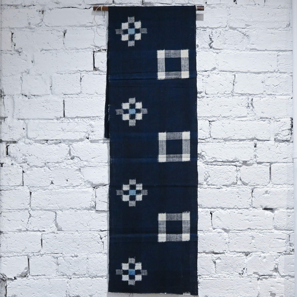 Full view of vintage Japanese indigo kasuri cotton panel from San'in region, a simple geometric pattern.