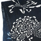 Close-up view of vintage indigo katazome cotton fragment with peony, chrysanthemum and noshi paper motifs.