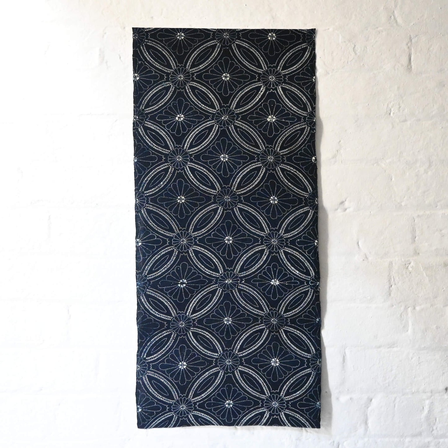 Full view of vintage indigo katazome cotton piece with Shippo-tsunagi with stylised chrysanthemum motif.