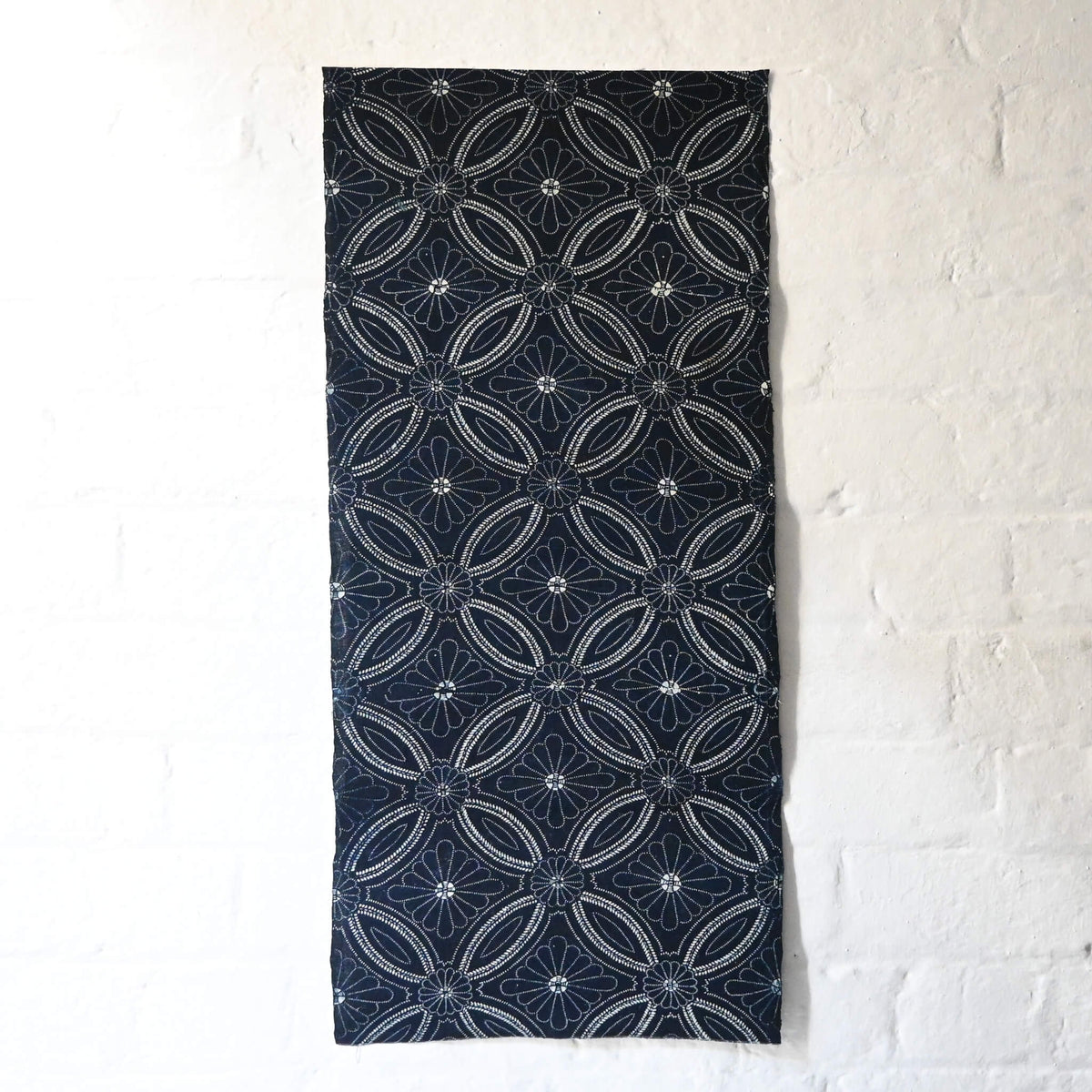 Full view of vintage indigo katazome cotton piece with Shippo-tsunagi with stylised chrysanthemum motif.
