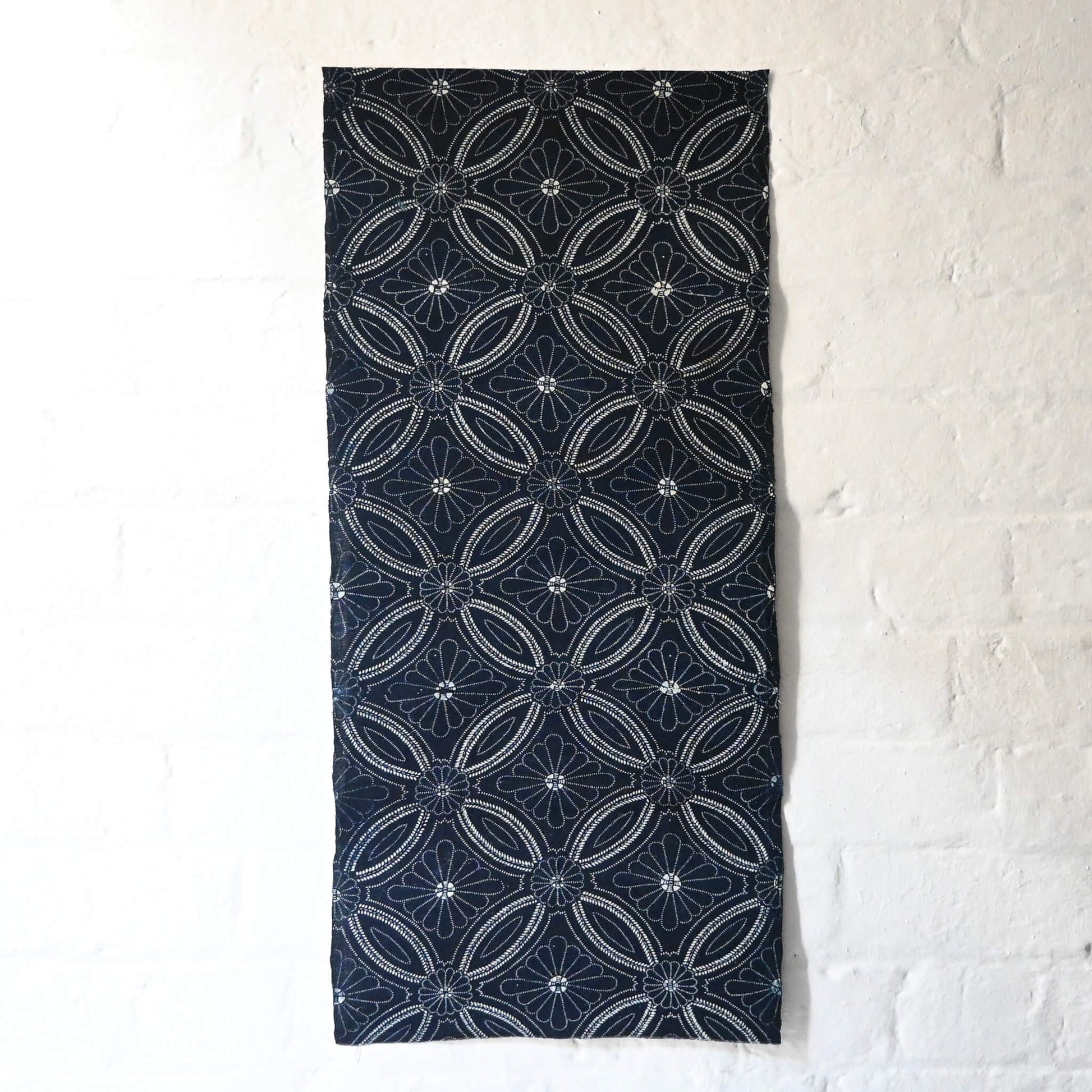 Full view of vintage indigo katazome cotton piece with Shippo-tsunagi with stylised chrysanthemum motif.