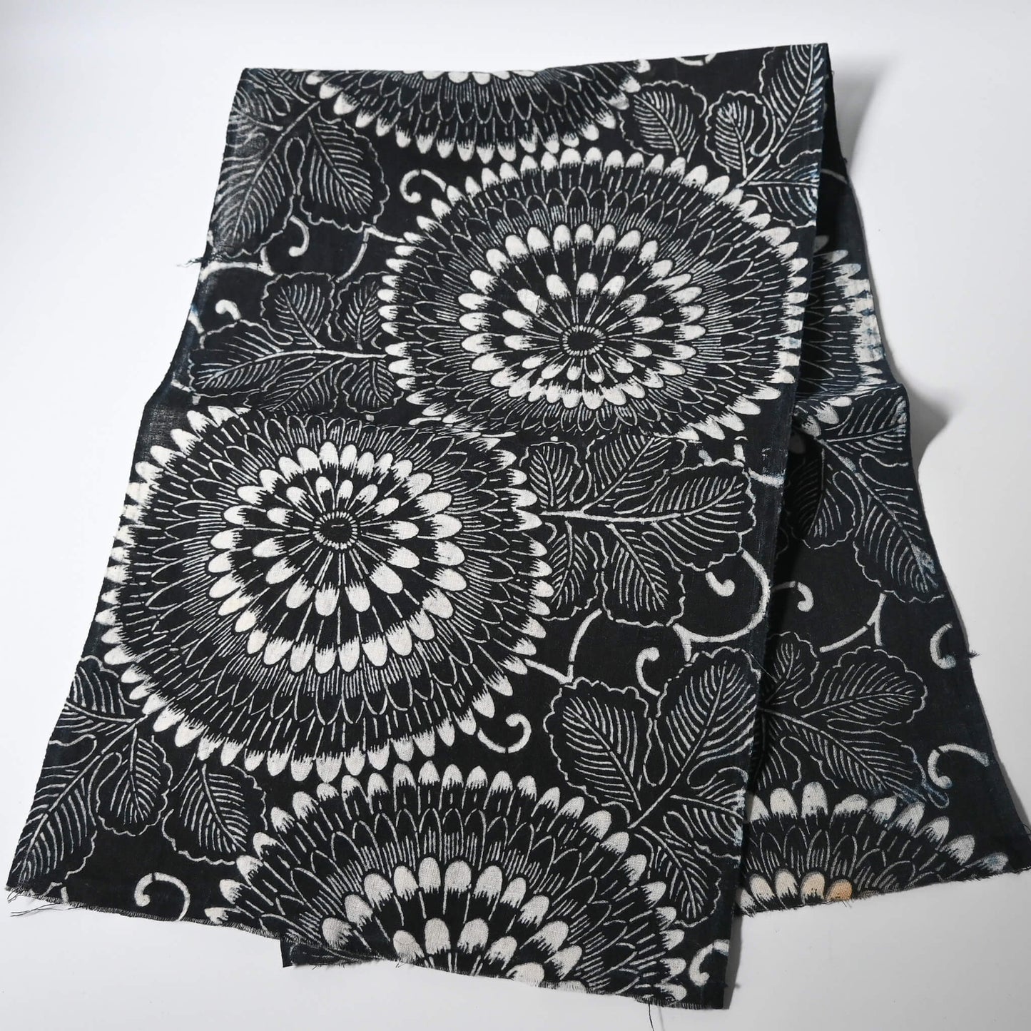 Full view of vintage indigo katazome stencil dyed cotton piece with a bold chrysanthemum design.