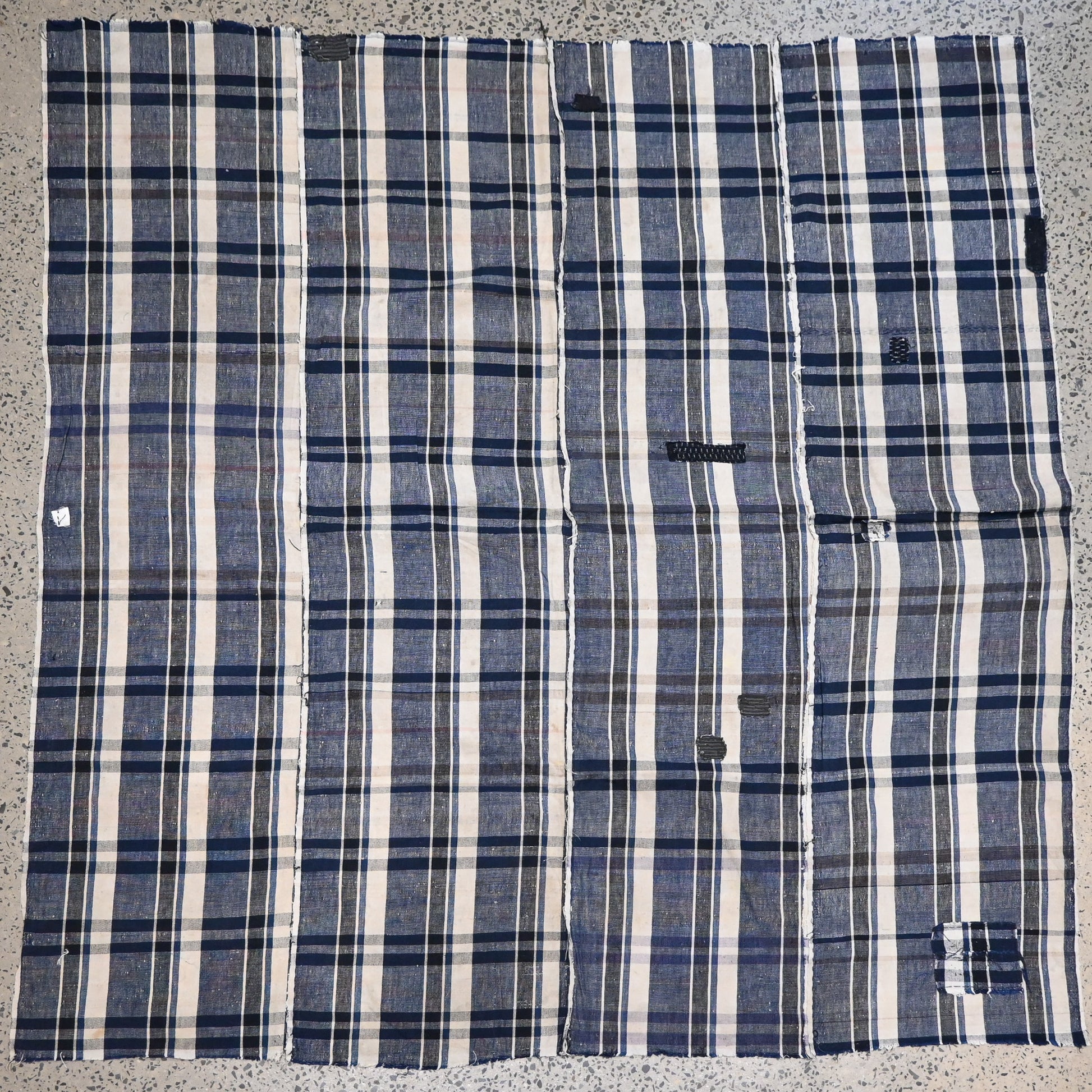 Full view of vintage Japanese indigo plaid cotton futon cover with some small mended patches.
