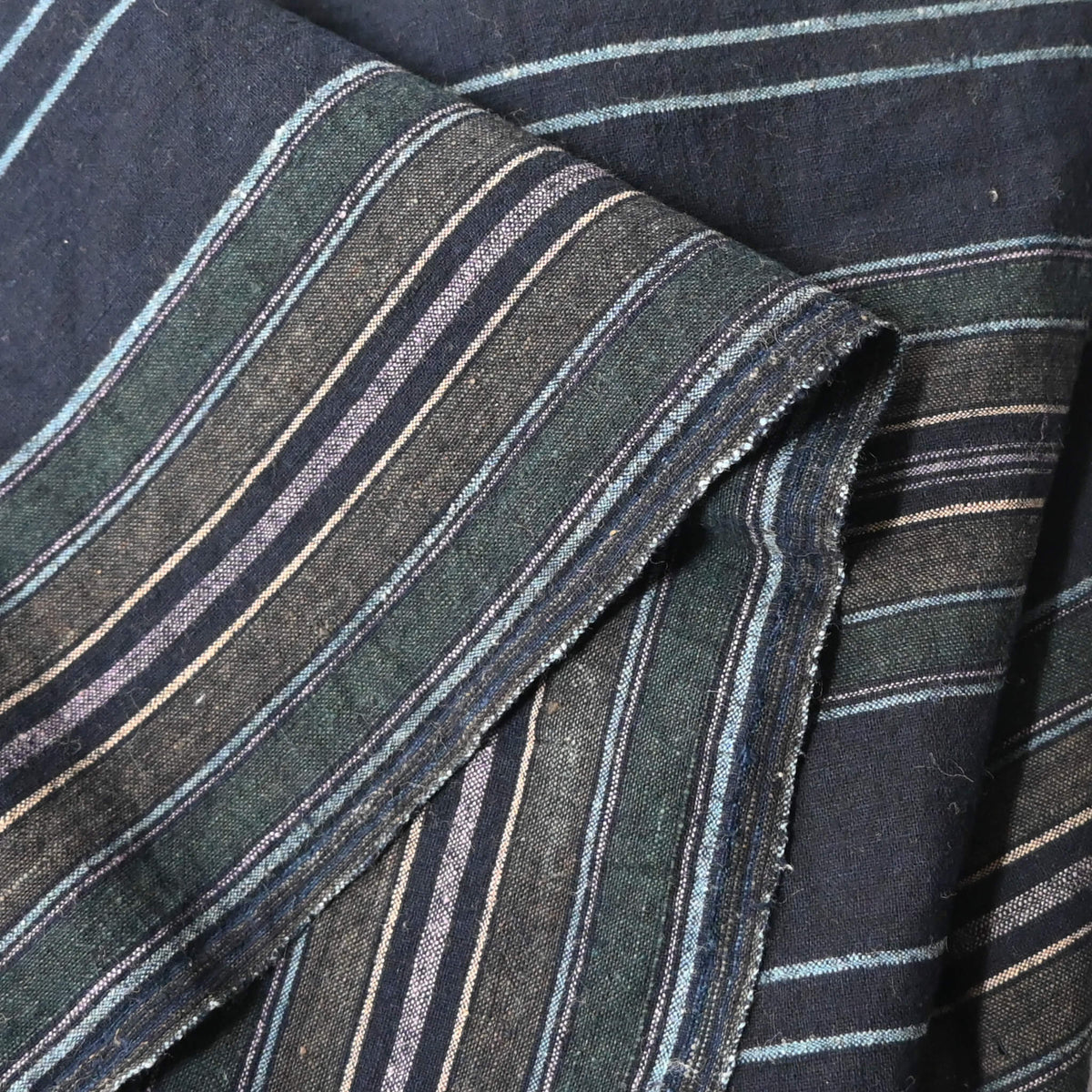 Close-up view of vintage Japanese indigo stripe cotton piece from a futon cover, mid-20th century.