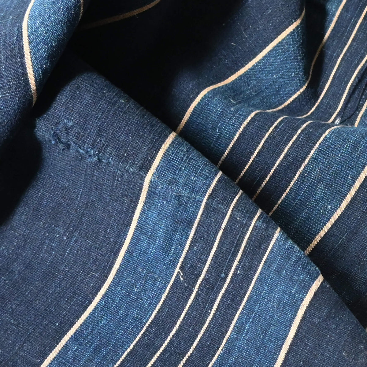 Close-up view of vintage Japanese indigo stripe cotton from futon cover.