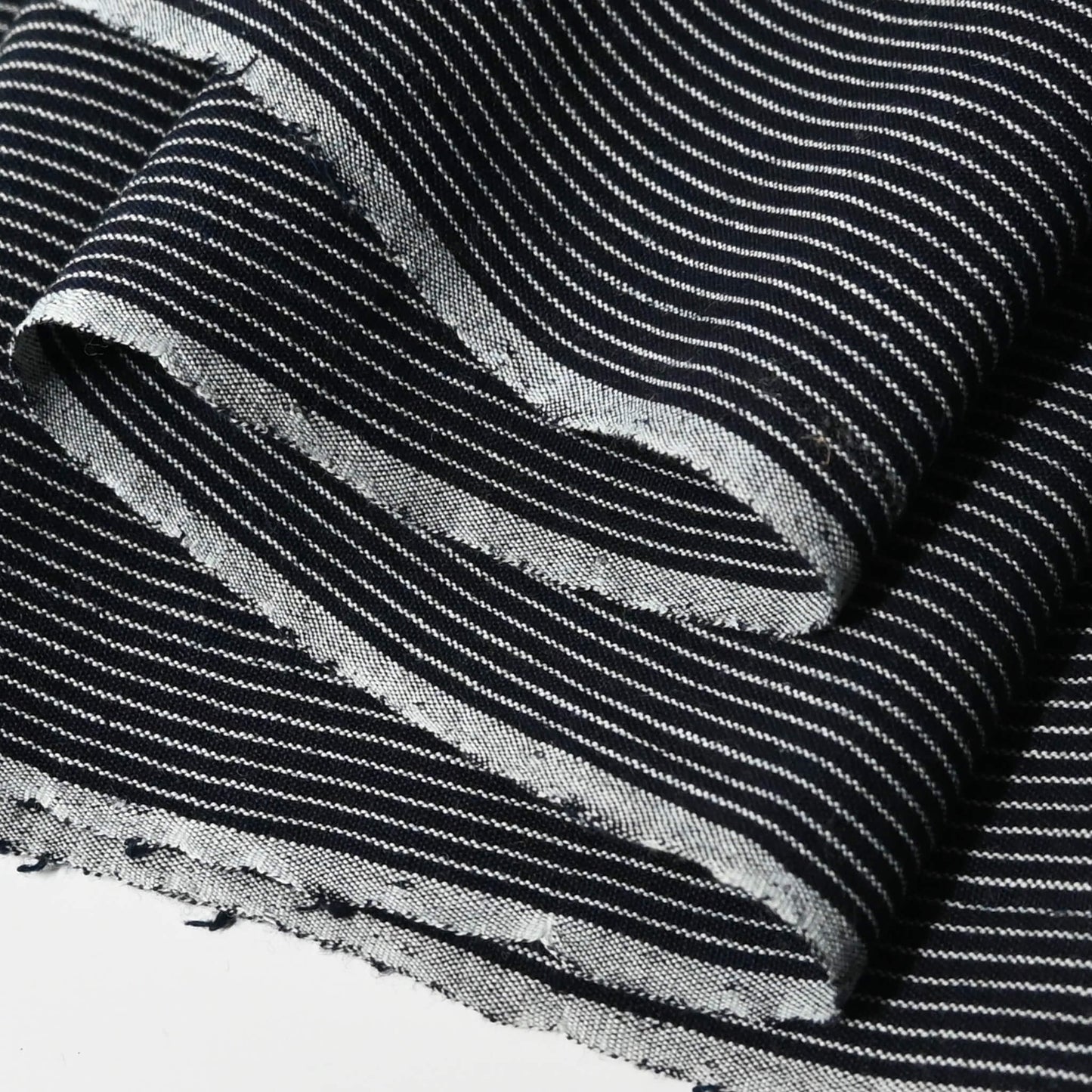 Close-up view of vintageJapanese heavy weight indigo stripe cotton fabric piece from undone kimono.