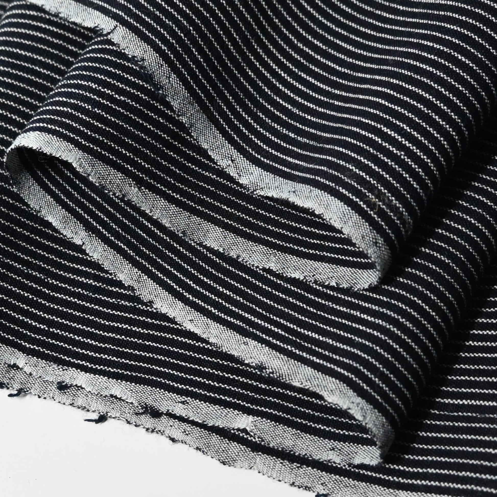 Close-up view of vintageJapanese heavy weight indigo stripe cotton fabric piece from undone kimono.