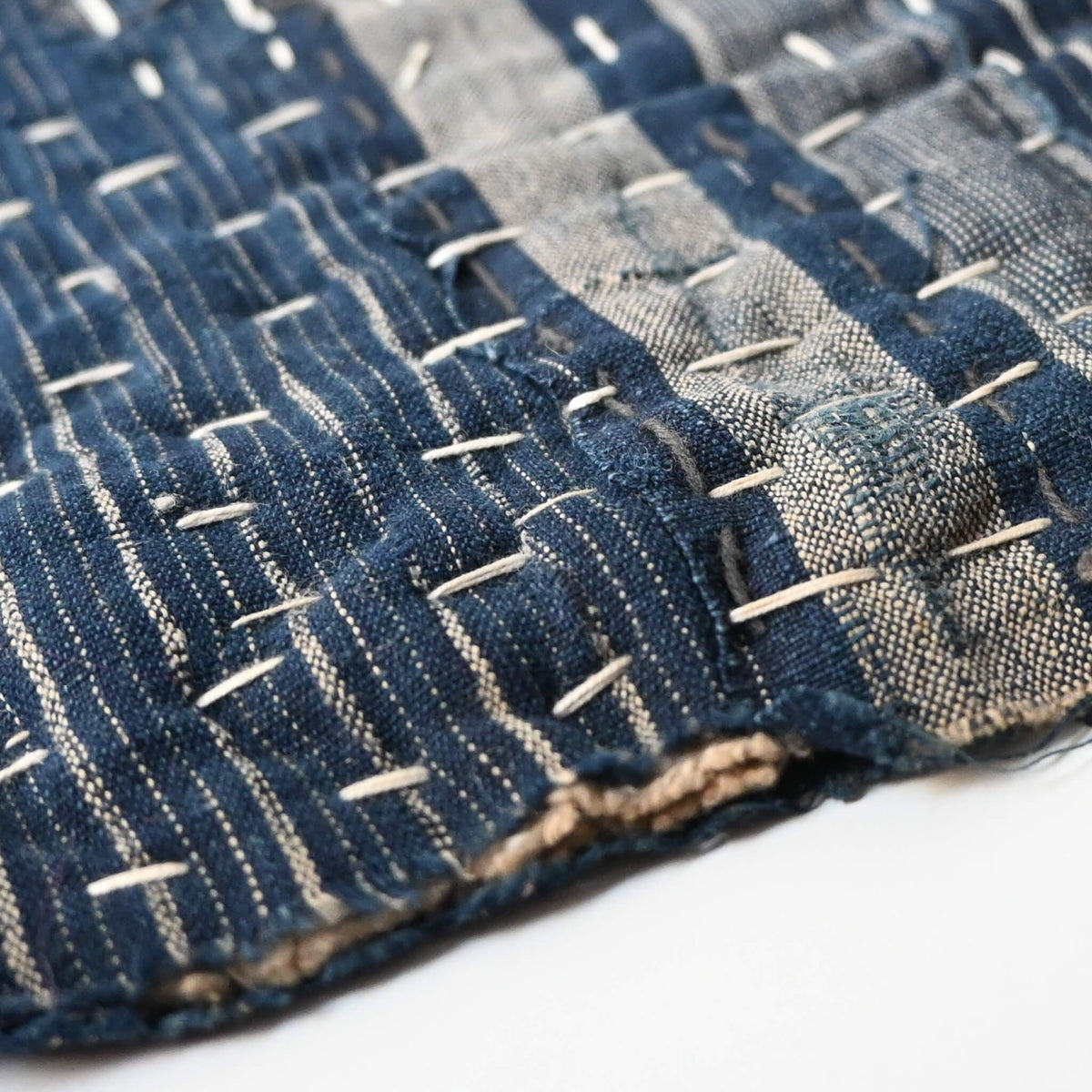 Close-up view of vintage Japanese indigo Zokin cleaning cloth made from old recycled pieces with hand sashiko stitching.