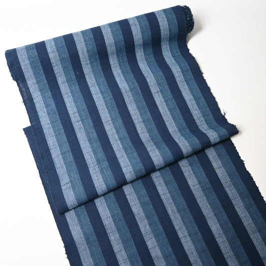 Full view of vintage Japanese indigo tsumugi stripe cotton fabric roll.