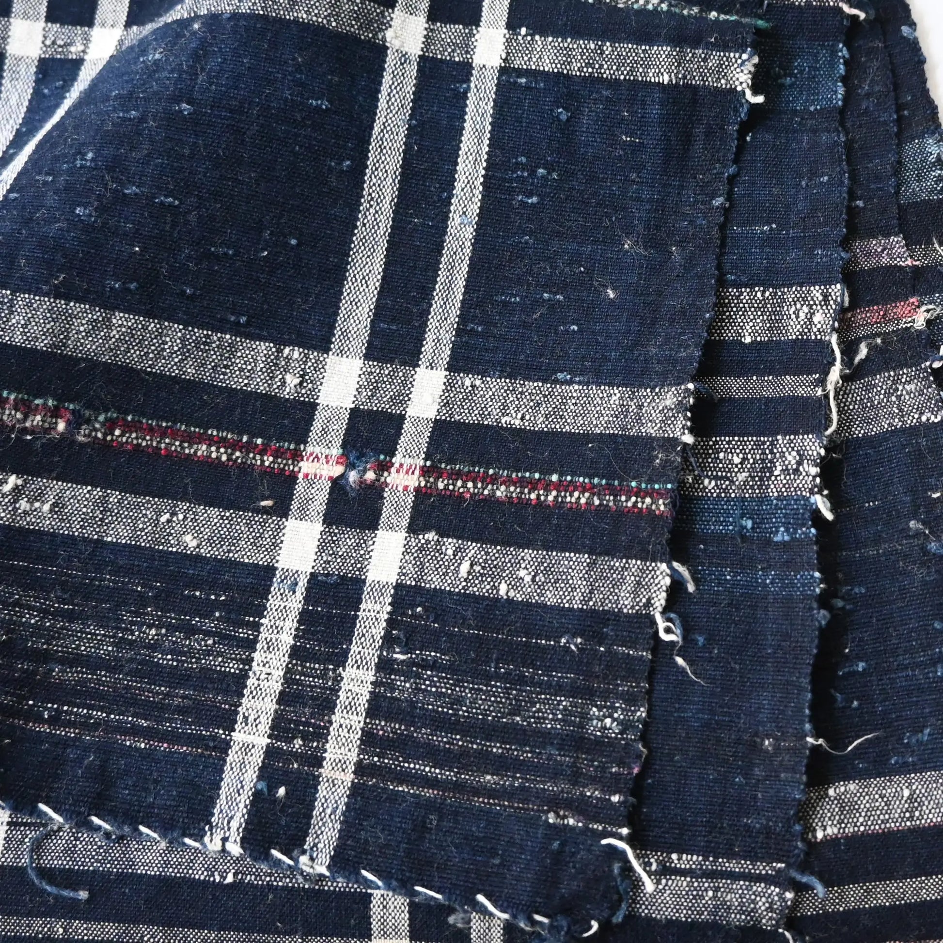 Close-up view of vintage Japanese indigo zanshi ori cotton with check pattern.