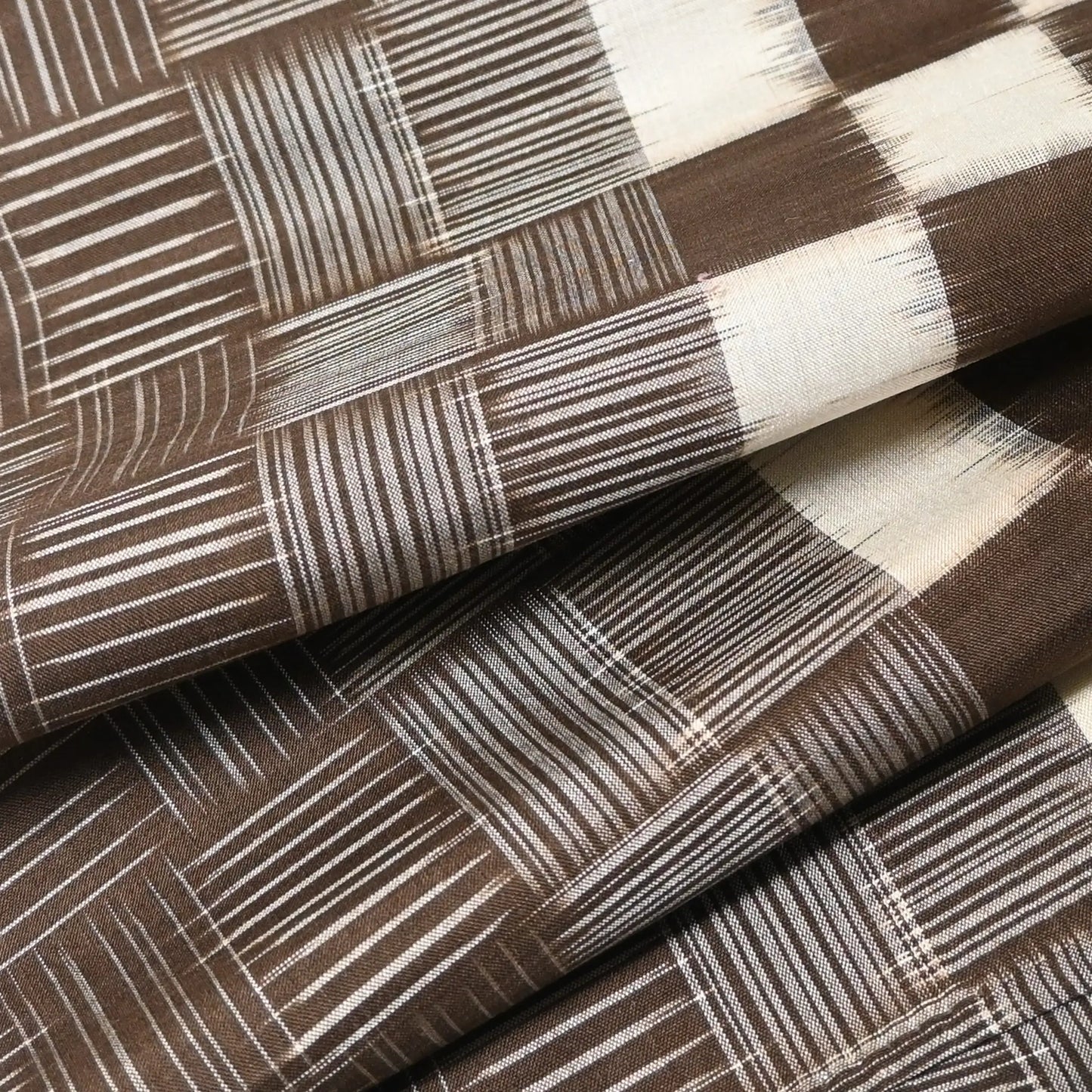 Close-upl view of vintage Isesaki Meisen silk kimono fabric with woven bold check pattern, mid-20th century.