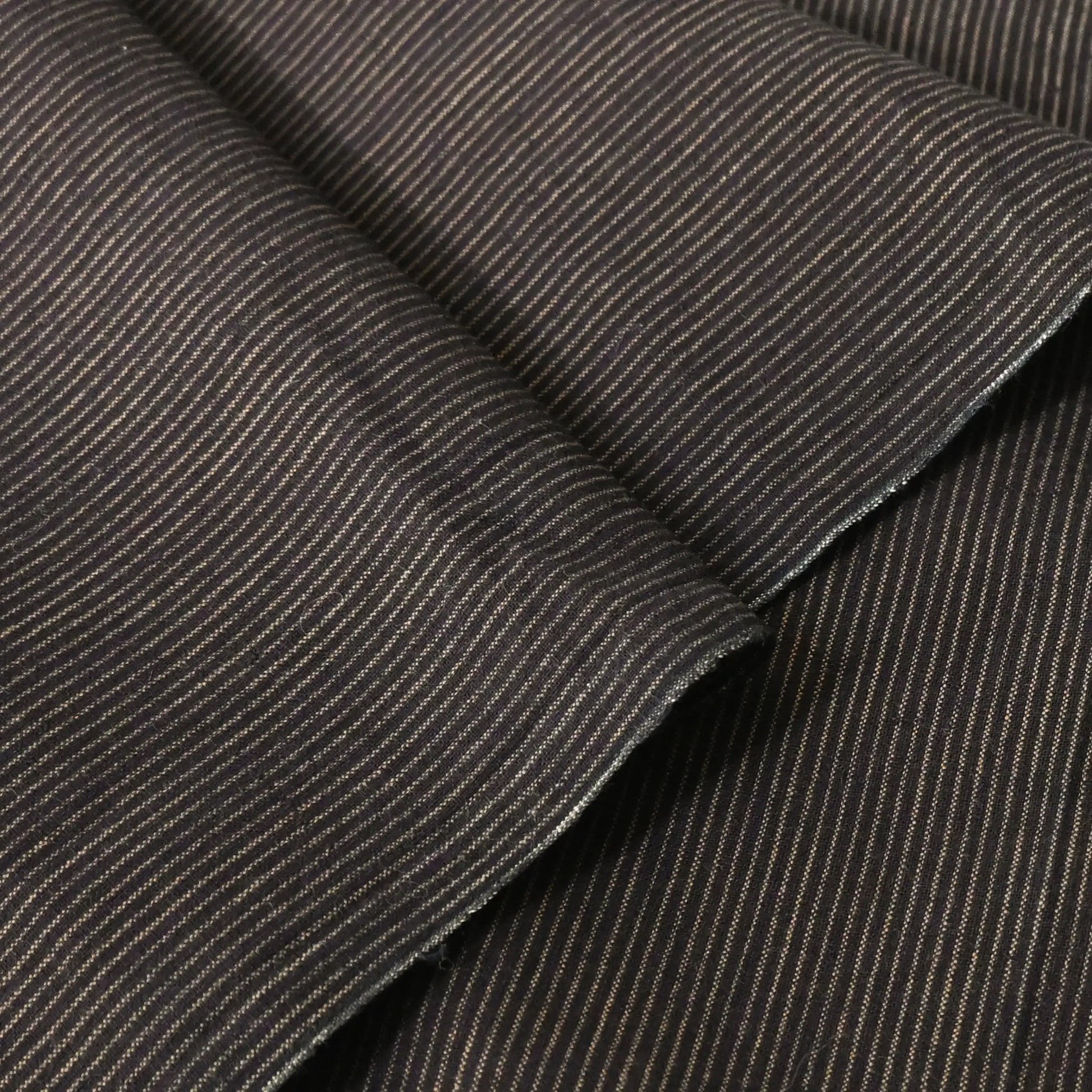 Detailed view of vintage Japanese indigo woven cotton piece with khaki brown pinstripes from the mid-20th century.