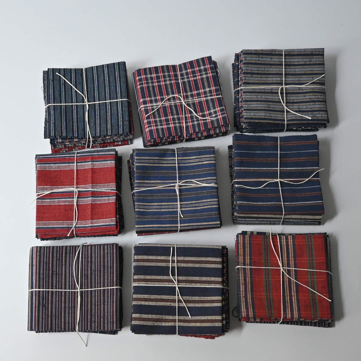 Set of five vintage Japanese cotton kimono fabric pieces in assorted checks and stripes.