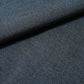 Close-up view of vintage dead stock men's tsumugi silk kimono fabric roll in dark sea tone.