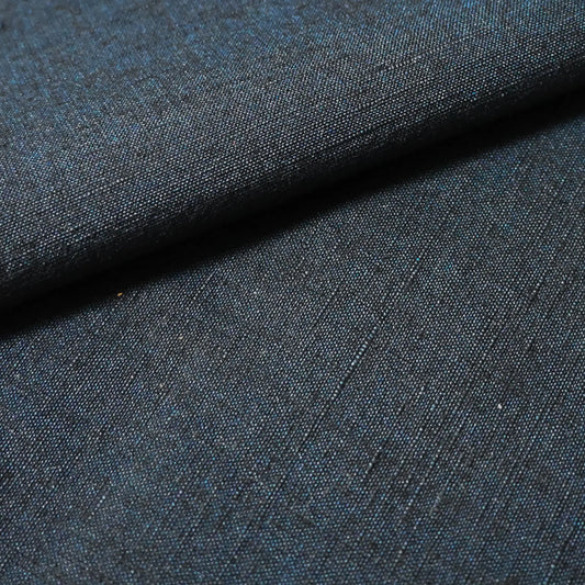 Close-up view of vintage dead stock men's tsumugi silk kimono fabric roll in dark sea tone.
