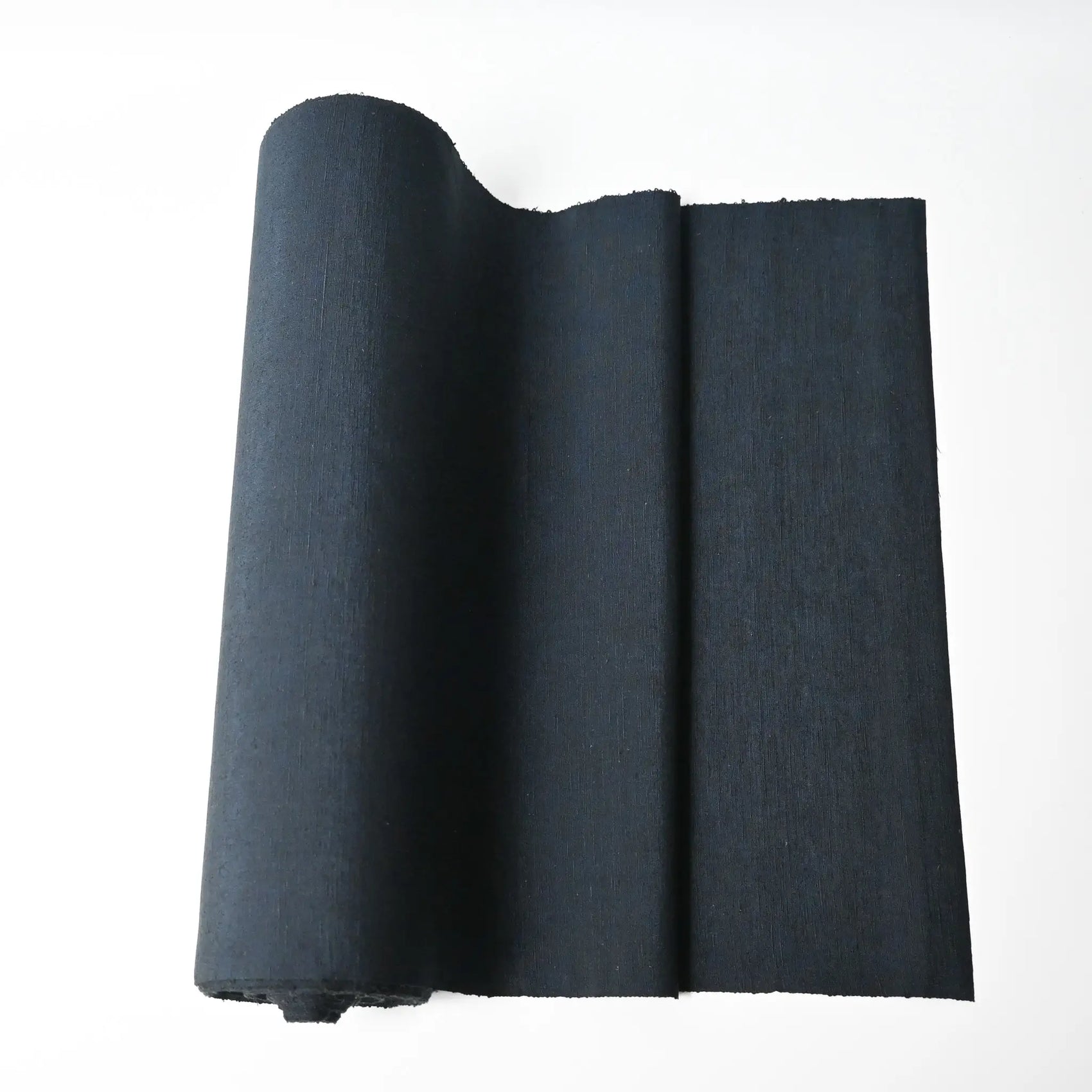 Vintage dead stock men's tsumugi silk kimono fabric roll in dark sea tone.