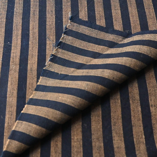 Detailed view of vintage Japanese indigo and brown stripe cotton fabric.