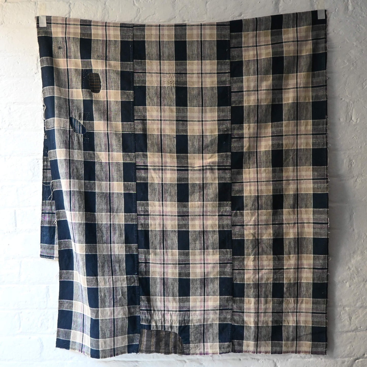 Full view of vintage Japanese indigo and soft pink check cotton futon cover with mended patches, boro textiles.