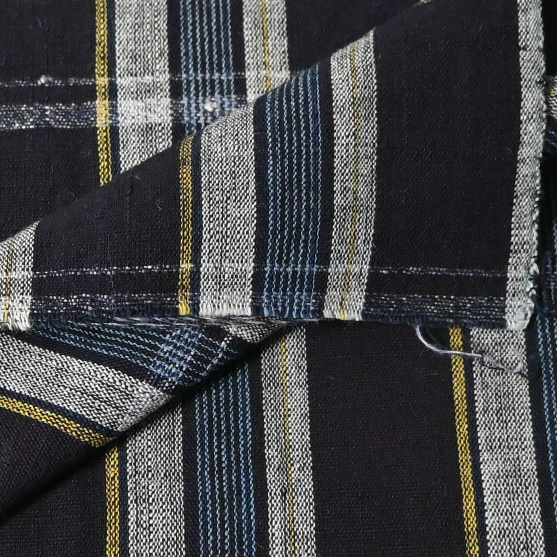 Close-up view of vintage Japanese indigo check cotton fabric piece.