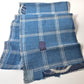 Detailed view of vintage Japanese indigo check cotton, boro mended piece from an old futon cover.