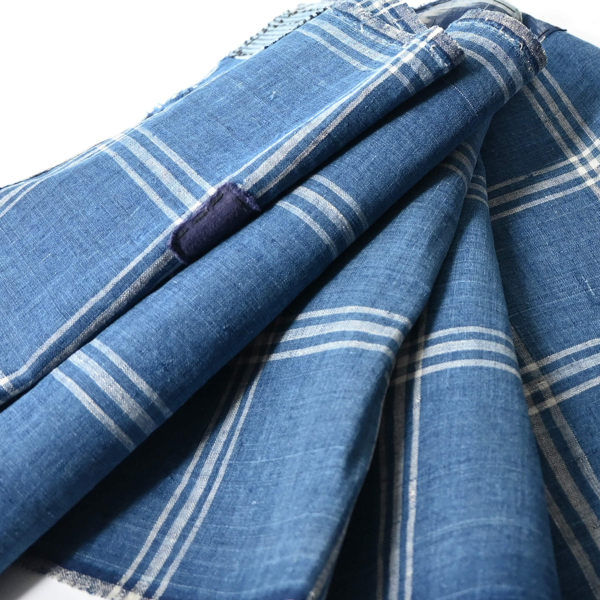 Close-up view of vintage Japanese indigo check cotton, boro mended piece from an old futon cover.