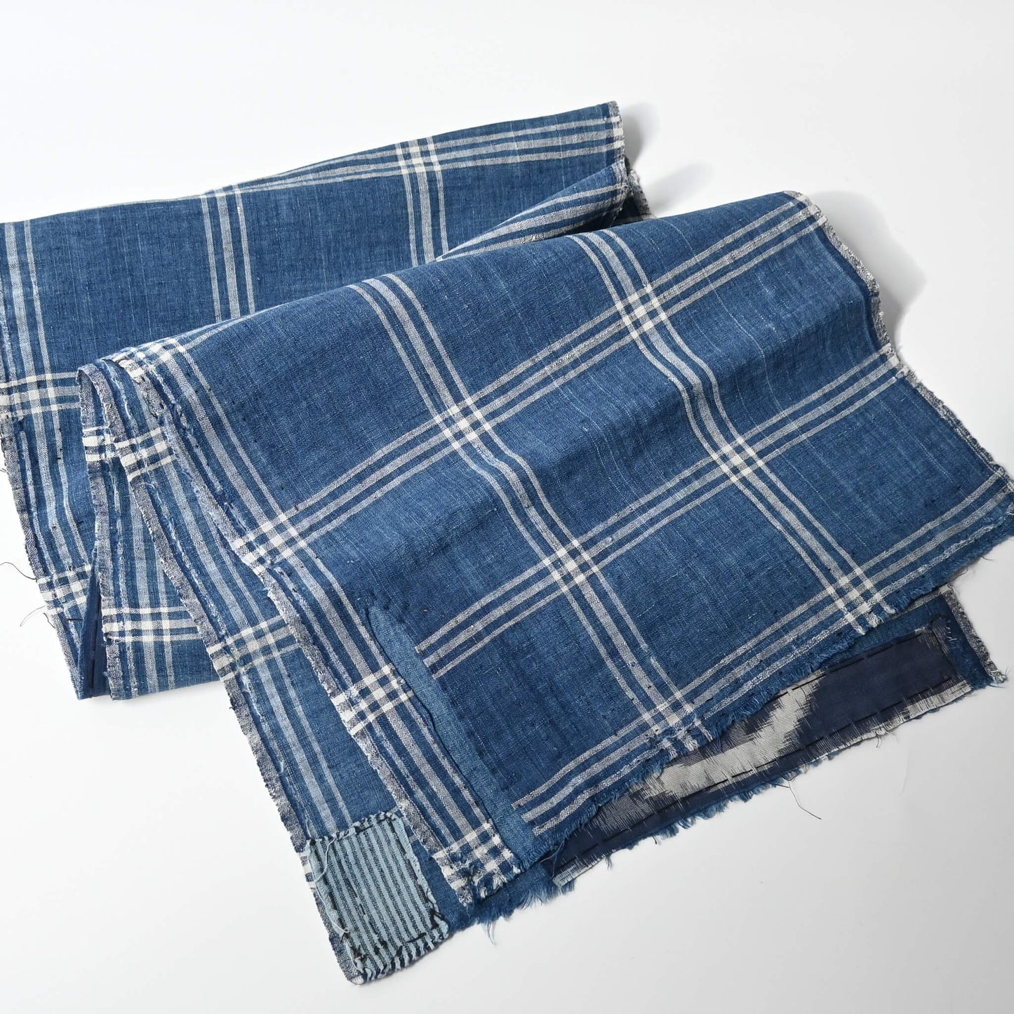 Full view of vintage Japanese indigo check cotton, boro mended piece from an old futon cover.
