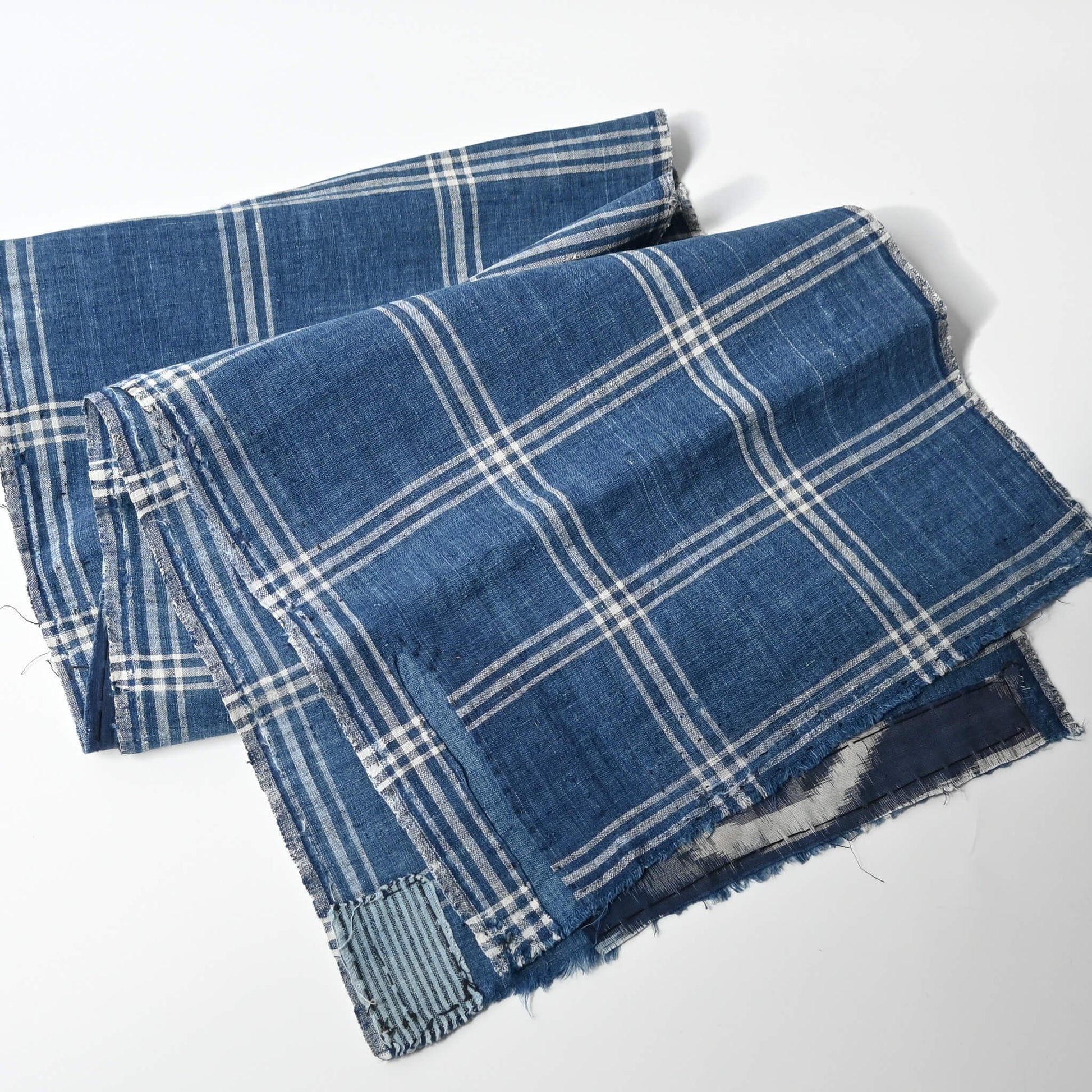 Full view of vintage Japanese indigo check cotton, boro mended piece from an old futon cover.