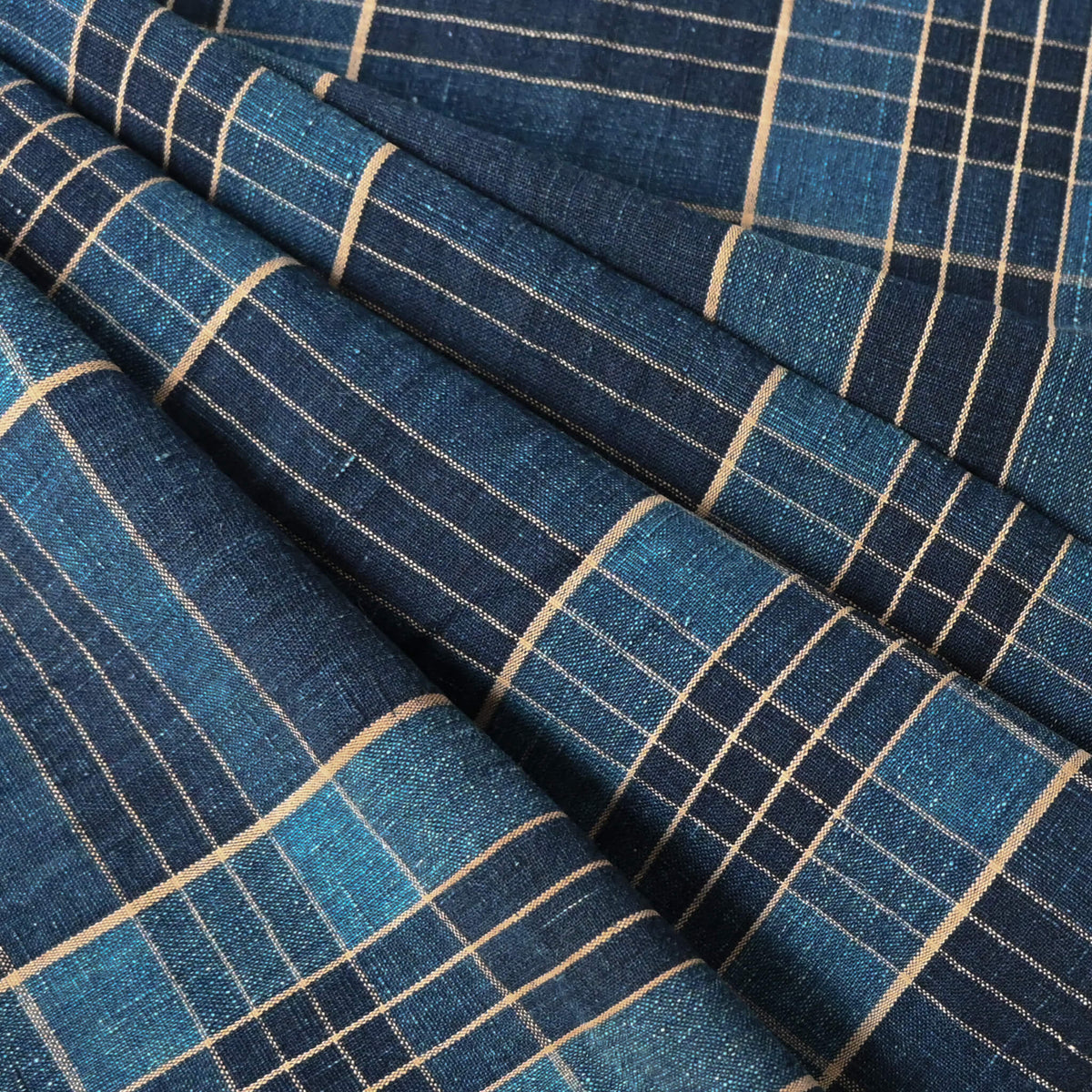 Close-up view of vintage Japanese indigo check cotton piece from old futon cover with mend.