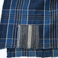 Close-up view of vintage Japanese indigo check cotton piece from old futon cover with mend.