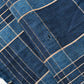 Close-up view of vintage Japanese indigo check cotton piece from old futon cover with mend.