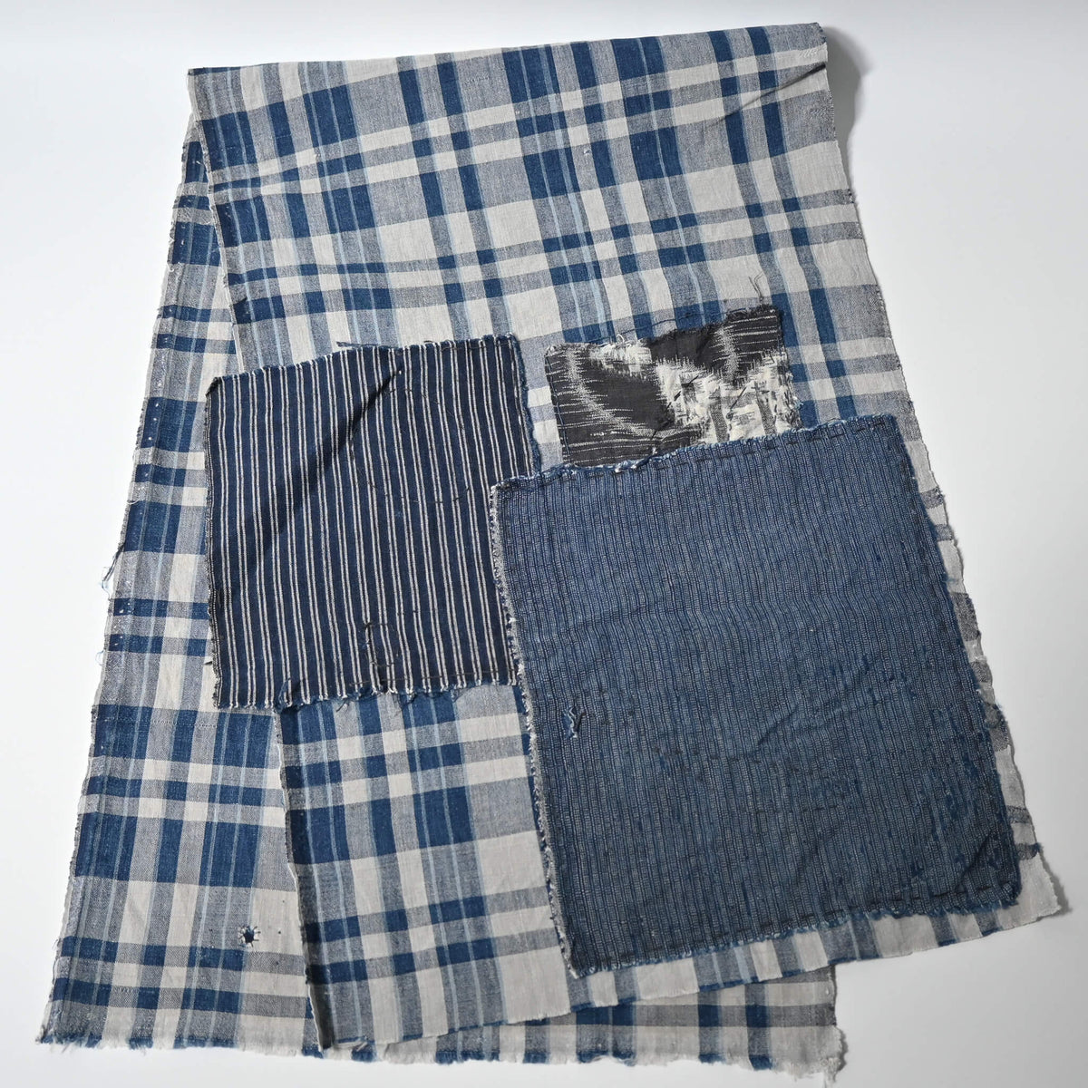 Back of vintage Japanese indigo cotton with hand-stitched repair, boro piece.