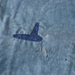 Detailed view of vintage Japanese indigo cotton furoshiki with various hand-stitched mends.