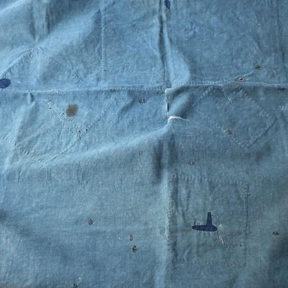 Vintage Japanese indigo cotton furoshiki with various hand-stitched mends, family crest and surname are dyed at corners.