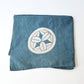 Vintage Japanese indigo cotton furoshiki with various hand-stitched mends, family crest and surname are dyed at corners.