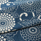 Close-up view of vintage Japanese indigo Katazome dyed cotton with chrysanthemum karakusa motif from the early 20th C.