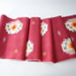 Vintage Japanese kasuri cotton kimono fabric roll in raspberry pink with a bold pattern from the mid 20th century.