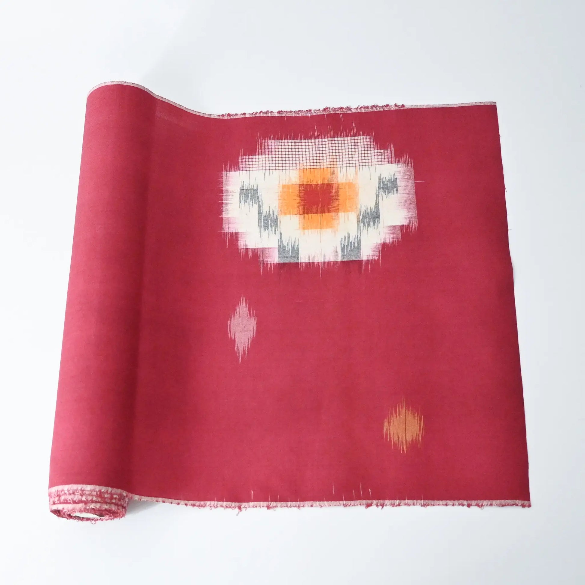 Vintage Japanese kasuri cotton kimono fabric roll in raspberry pink with a bold pattern from the mid 20th century.